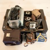 A group of vintage cameras including Kodak, video camera, etc.
