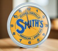A reproduction Smiths Jeans & Overalls battery wall timepiece, diameter 40 cm.