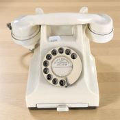 A cream bakelite GPO telephone.