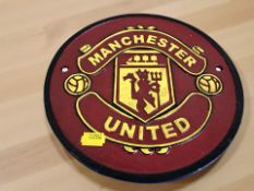 A painted cast metal Manchester United plaque,