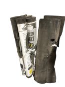 Eight various rolls of roofing felt.