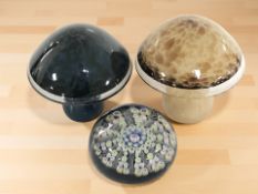 Two Wedgwood glass mushroom paperweights, and a further millefiori paperweight.