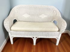 A wicker two seater conservatory settee, matching armchair, a further wicker chair and table.