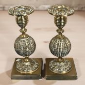 A pair of ornate Victorian brass candlesticks, height 18 cm.