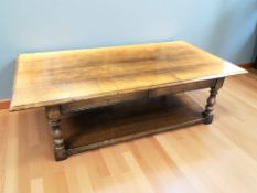 A reproduction oak rectangular coffee table, 150 cm x 80 cm x 45 cm.