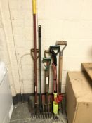 A group of garden hand and power tools.