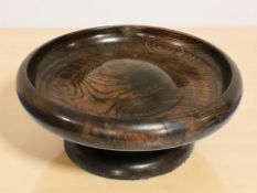A turned wooden fruitbowl, diameter 25 cm, and a further decorative pottery bowl.