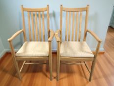 A pair of Ercol elm armchairs, width 58 cm.