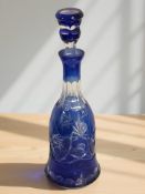 A blue glass flash cut decanter and stopper, height 35 cm.