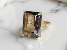 A yellow gold smokey quartz dress ring, size O. CONDITION REPORT: Tested around 12ct.