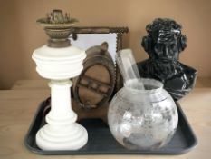 A composition bust of Homer, an oak barrel with cups on the stand, and an oil lamp.