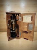 An Ernst Leitz Wetzlar lacquered brass microscope, numbered 94052, with accessories,