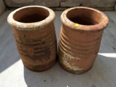 A pair of terracotta chimney caps, height 41 cm.