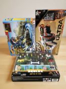 A Nerf gun, a Roblox forty piece toy set, and a Hot Wheels monster trucks racing set.