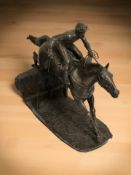 A Heredities figure of a jockey on horseback, height 28 cm.