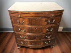An early 20th century mahogany bow-front four drawer bachelor's chest with brush slide and later