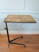 A 20th century reading table on cast metal support, width 65 cm.