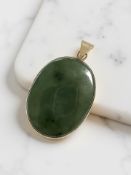 A 9ct yellow gold-mounted jadeite oval pendant,