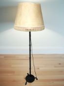 A wrought iron standard lamp.