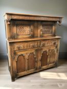 A 20th century carved oak court cupboard,