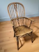 A 19th century elm spindleback Windsor kitchen armchair, width 56 cm.