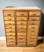 A mid 20th century pine and plywood twenty seven drawer shop storage chest, 90 cm x 32 cm x 108 cm.