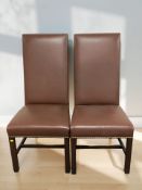 A pair of reproduction high backed studded leather chairs.