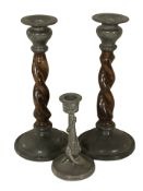 A pair of oak and pewter barley twist candlesticks, height 23 cm, and a further pewter candlestick.
