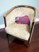 An early 20th century mahogany tub armchair in floral fabric.
