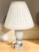 A carved alabaster table lamp with shade, height 44 cm.