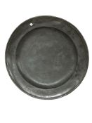 An 18th century pewter charger, diameter 45 cm.