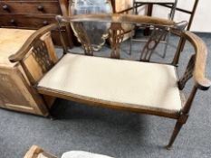 An Edwardian beech and satinwood inlaid two seater salon settee, width 108 cm.
