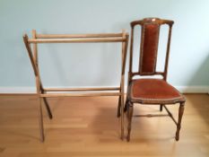 An x-framed wooden towel rail and an antique occasional chair.