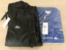 A Lacoste Sport polo shirt, size 8, and a Lacoste black hoodie, size 4.