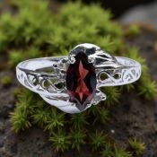 A white gold garnet solitaire ring, stamped 10k, size N CONDITION REPORT: 1.