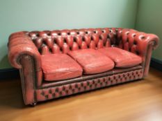 A 20th century oxblood leather chesterfield three seater settee, 193 cm x 95 cm x 70 cm.