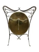 A Victorian wrought iron and brass Art Nouveau fire screen, height 81 cm.