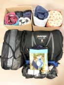 A collection of camping and outdoor equipment, sleeping bags, tents, etc.