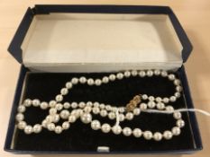 A single-strand cultured pearl necklace with 9ct gold clasp,