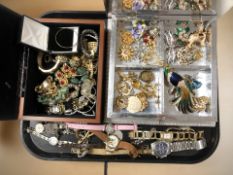 A collection of costume jewellery including decorative enameled brooches, some silver items,