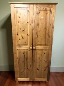 A modern pine double door wardrobe, 90 cm x 55 cm x 179 cm.
