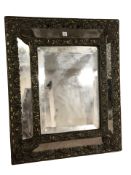 A 19th century embossed brass cushion mirror, 40 cm x 30 cm.