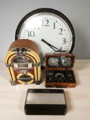 A large reproduction wall clock together with a radio in the form of a jukebox,