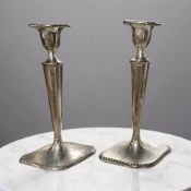 A pair of Edward VII loaded silver candlesticks, London 1907, height 23cm.