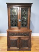A late Victorian Arts and Crafts period walnut double door secretaire bookcase with stained and