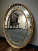 A late 19th century gilt gesso oval mirror, 112 cm x 82 cm.