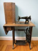 A Singer treadle sewing machine in oak table.