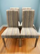 A contemporary set of four high backed dining chairs in striped upholstery.