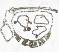 A group of silver jewellery, medallions, bracelets, etc.