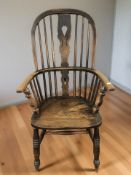 A 19th century elm spindle back Windsor kitchen armchair, width 58 cm.
